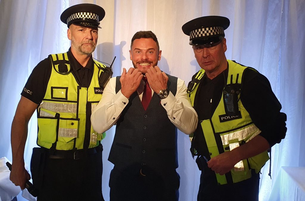 Singing Police detaining an unsuspecting guest