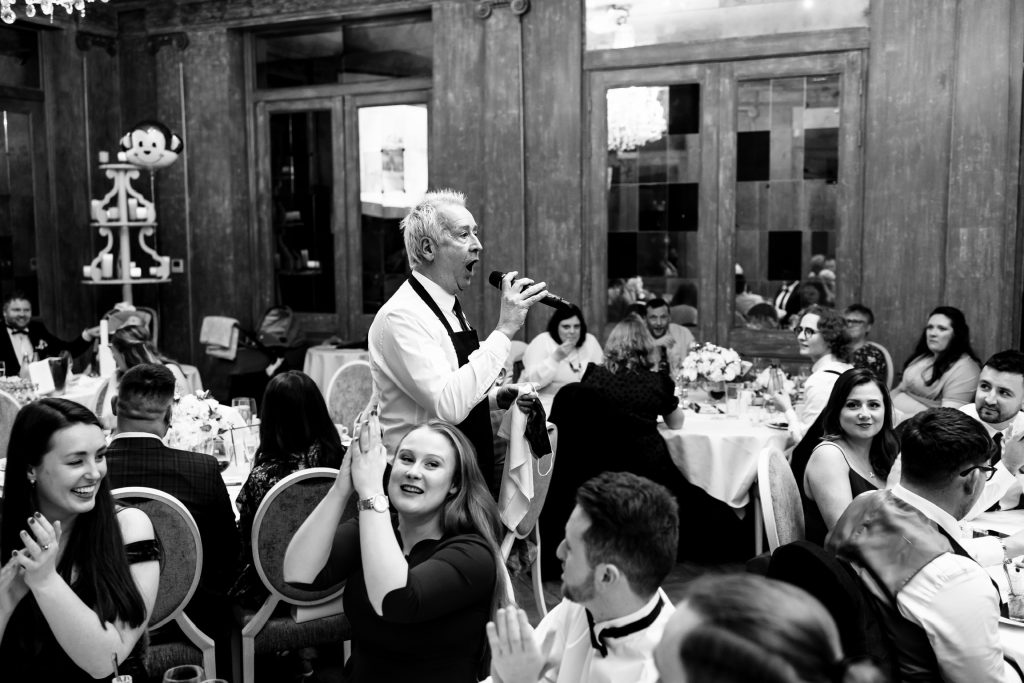 Singing waiter singing to the guests